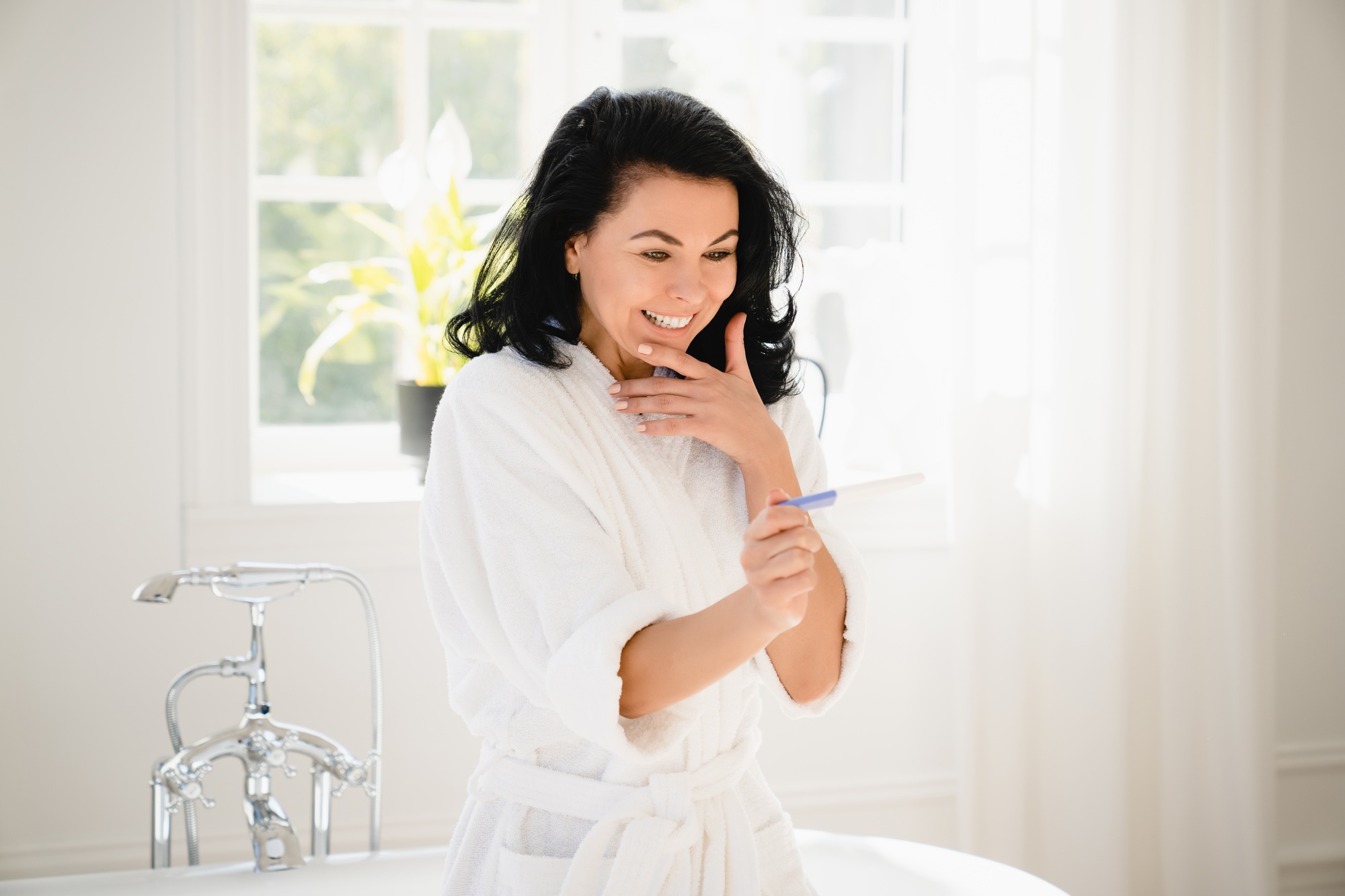 Mature woman having positive pregnancy test result. Two stripes. Future mother, fertility concept